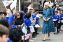 Queen Camilla is greeted by pupils in the courtyard of Moreland Primary School