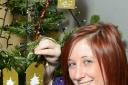 Garden centre assistant Holly Marshfeild puts her memory on the tree to raise cash for the Alzheimer's Society