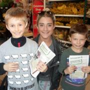 Jacob and Jonah Stanton receive a donation from former X Factor contestant Katie Waissel at Tesco, Hampstead.