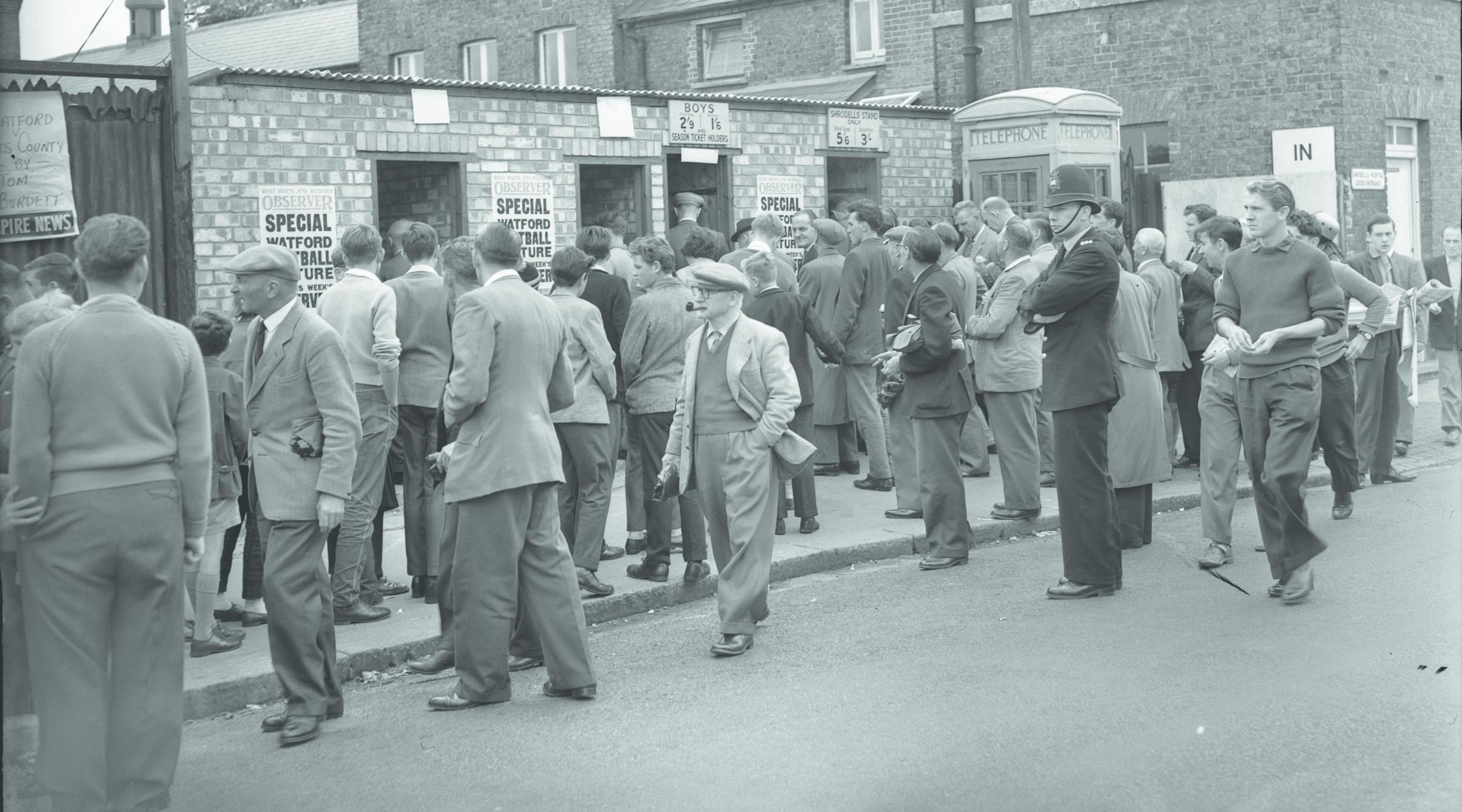 An old Watford Observer image of fans flocking through the turnstiles