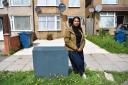 Laxmi Kerai at her property in Harrow, West London - She is annoyed that a Virgin Media cable box is in front of her drive, meaning she can’t get a dropped kerb if she wants to. photographer byline Darren Pepe..