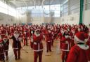 The Santas took part in a group warm up before the Dash