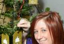 Garden centre assistant Holly Marshfeild puts her memory on the tree to raise cash for the Alzheimer's Society