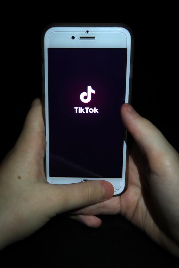 Harrow Times: A person with TikTok open on their phone. Credit: PA