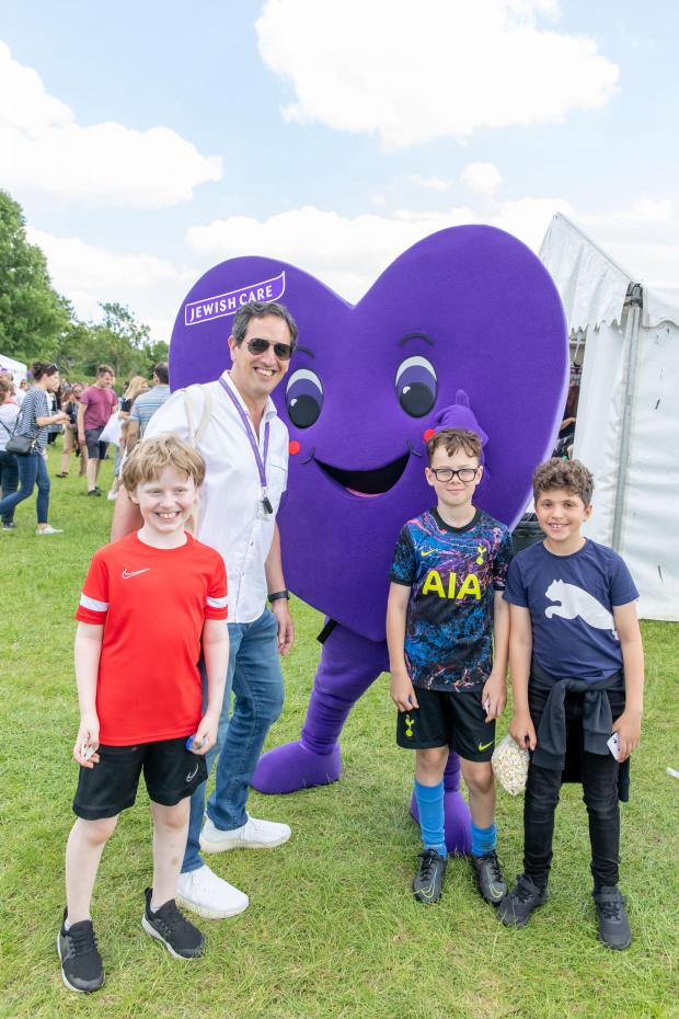 Harrow Times: Jewish Care chief executive Daniel Carmel-Brown with Jewish Care's mascots and young attendees. Credit: Justin Grainge