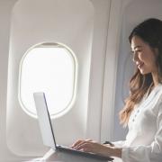 A woman on a laptop on a plane. Credit: EFR Travel Group