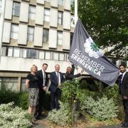 Cllr Sue Anderson, Tom Whiting, Harrow Council chief executive, Bob Blackman, MP for Harrow East, Cllr Nitin Parekh and Cllr Krishna Suresh raise a flag in honour of Srebrenica